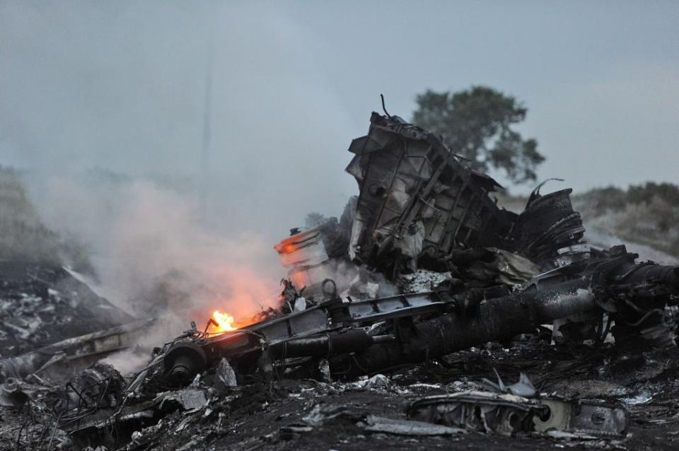 A fire burns amid the wreckage of Malaysia Airlines Flight 17