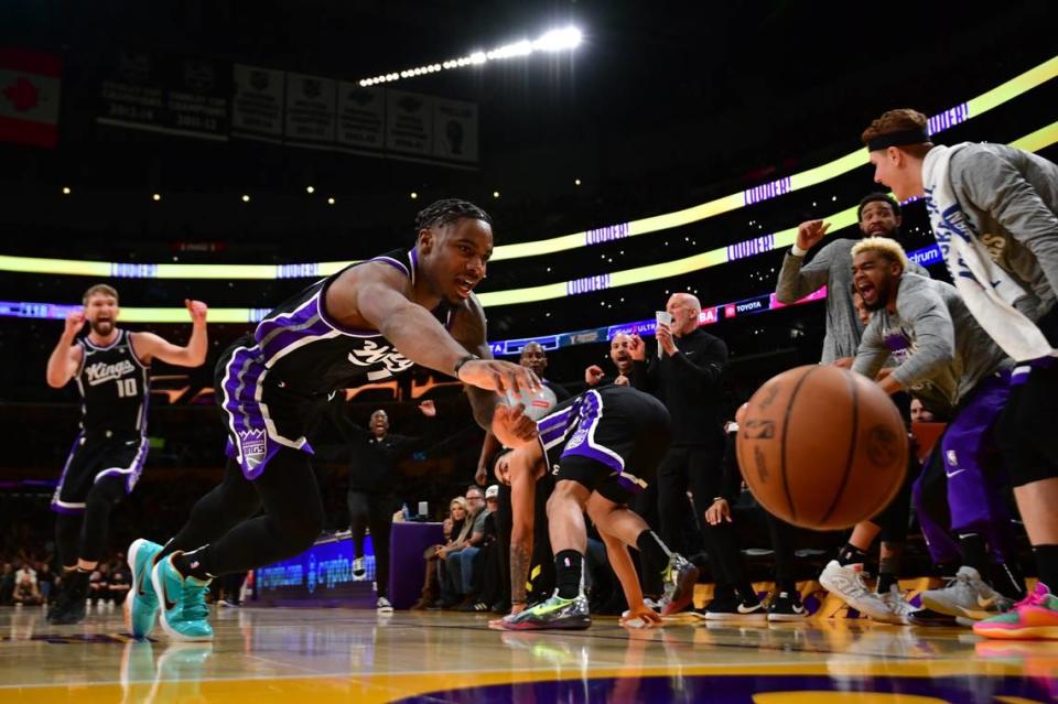 Sacramento Kings guard Davion Mitchell (15) tries to keep the ball inbound against the Los Angeles Lakers during the second half Wednesday at Crypto.com Arena in Los Angeles.