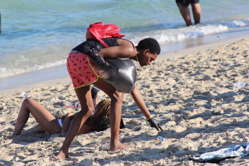 Joshua Caraway was photographed picking up litter on Miami Beach on March 23. (Credit: Joel Franco/WSVN)