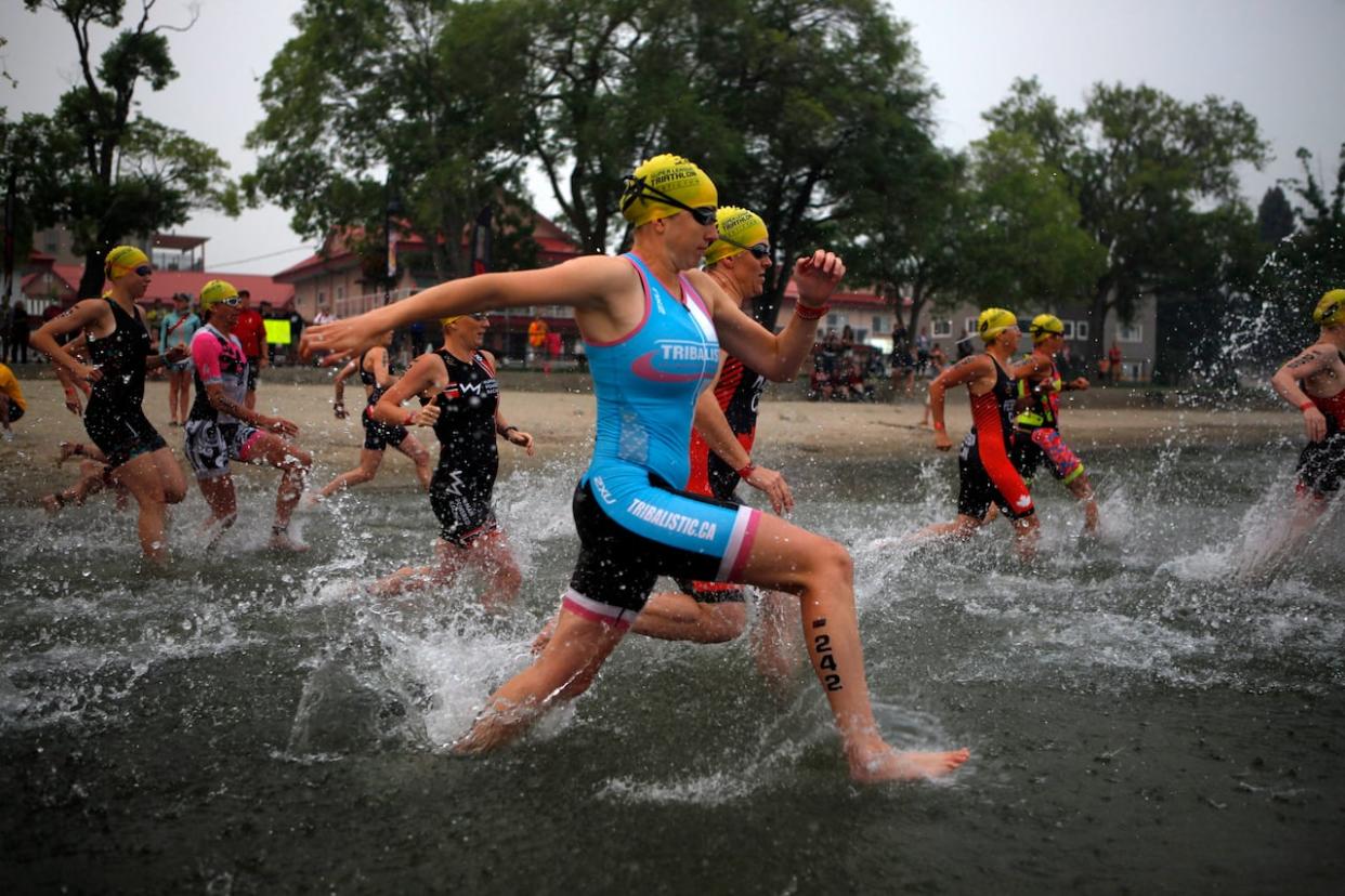 The Penticton Ironman, which was set to welcome 2,000 competitors, has been cancelled this year after non-essential travel restrictions were introduced in B.C.'s southern Interior due to major wildfires.  (Chad Hipolito/THE CANADIAN PRESS - image credit)