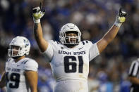 Utah State offensive lineman Weylin Lapuaho (61) celebrates a touchdown by the team against BYU during the first half of an NCAA college football game Thursday, Sept. 29, 2022, in Provo, Utah. (AP Photo/Rick Bowmer)