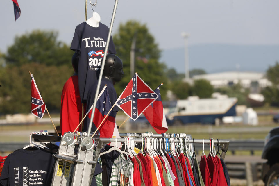 A vendor displays Confederate Battle flags as well as Trump 2020 flags across from the Speedway during the NASCAR Xfinity auto race at the Talladega Superspeedway in Talladega Ala., Saturday June 20, 2020 (AP Photo/John Bazemore)