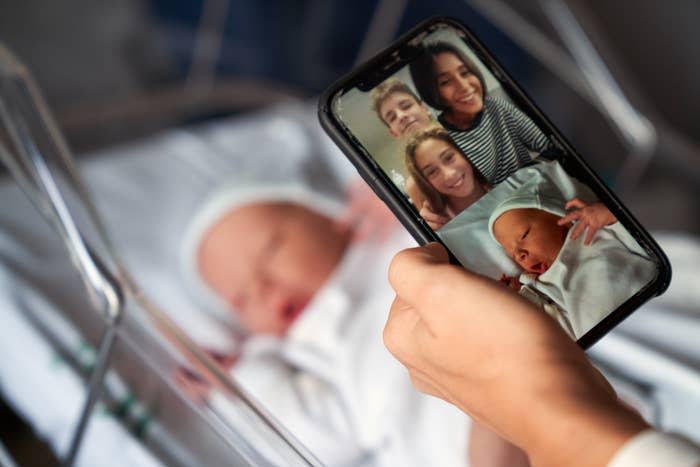 Someone FaceTiming their family to show their newborn baby