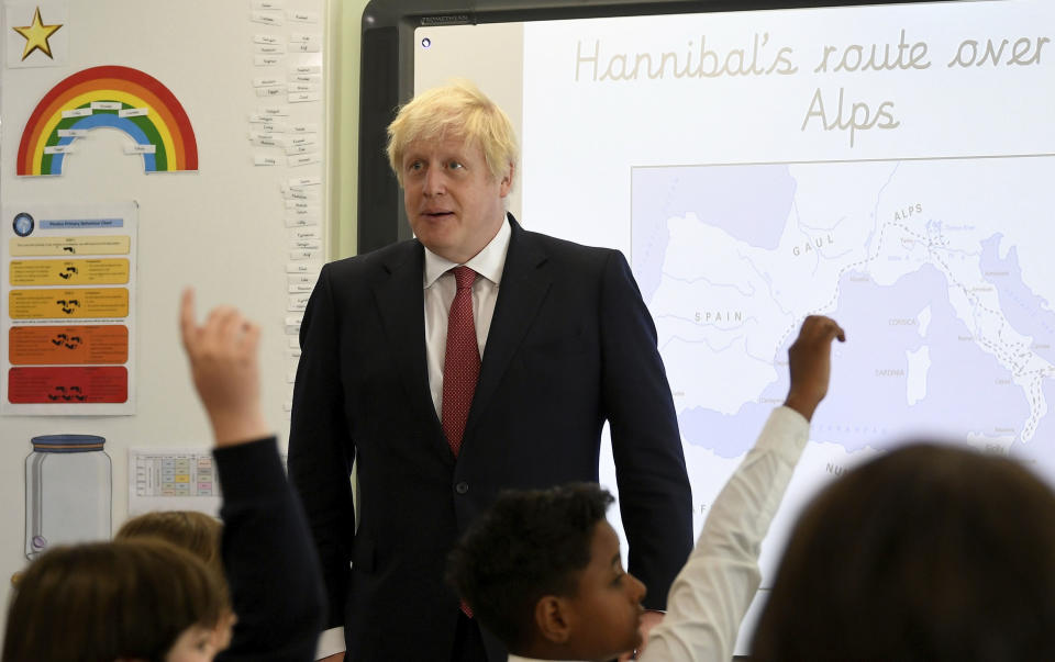 Britain's Prime Minister Boris Johnson, left, visits Pimlico Primary school in London, Tuesday July 10, 2018, to meet staff and students. (Toby Melville/Pool via AP)