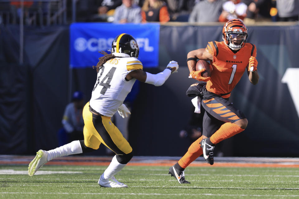 Cincinnati Bengals wide receiver Ja'Marr Chase (1) runs away from Pittsburgh Steelers safety Terrell Edmunds (34) during the first half of an NFL football game, Sunday, Nov. 28, 2021, in Cincinnati. (AP Photo/Aaron Doster)