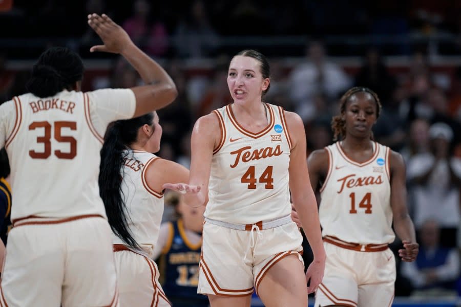 Texas forward Taylor Jones (44) celebrates a score with teammate Madison Booker (35) during the second half of a first-round college basketball game against Drexel in the women’s NCAA Tournament in Austin, Texas, Friday, March 22, 2024. (AP Photo/Eric Gay)