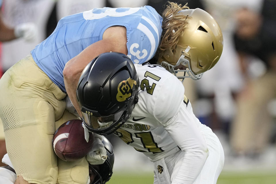 Colorado safety Shilo Sanders, right, forces a fumble by UCLA running back Carson Steele during the first half of an NCAA college football game Saturday, Oct. 28, 2023, in Pasadena, Calif. Colorado recovered the ball. (AP Photo/Mark J. Terrill)