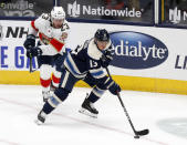 Columbus Blue Jackets forward Cam Atkinson, right, controls the puck in front of Florida Panthers forward Carter Verhaeghe during the first period of an NHL hockey game in Columbus, Ohio, Tuesday, Jan. 26, 2021. (AP Photo/Paul Vernon)