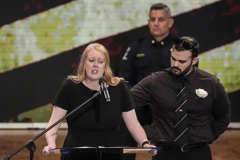 Widow of officer Joshua Eyer, Ashley Eyer speaks during a memorial service for Officer Joshua Eyer, Friday, May 3, 2024, in Charlotte, N.C. Police in North Carolina say a shootout that killed Eyer and wounded and killed other officers began as officers approached a home to serve a felony warrant on Monday. (AP Photo/Chris Carlson)