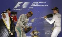 Third-placed Mercedes Formula One driver Nico Rosberg of Germany sprays champagne to race winner and team mate Lewis Hamilton of Britain after Bahrain's F1 Grand Prix at Bahrain International Circuit, south of Manama April 19, 2015. REUTERS/Ahmed Jadallah