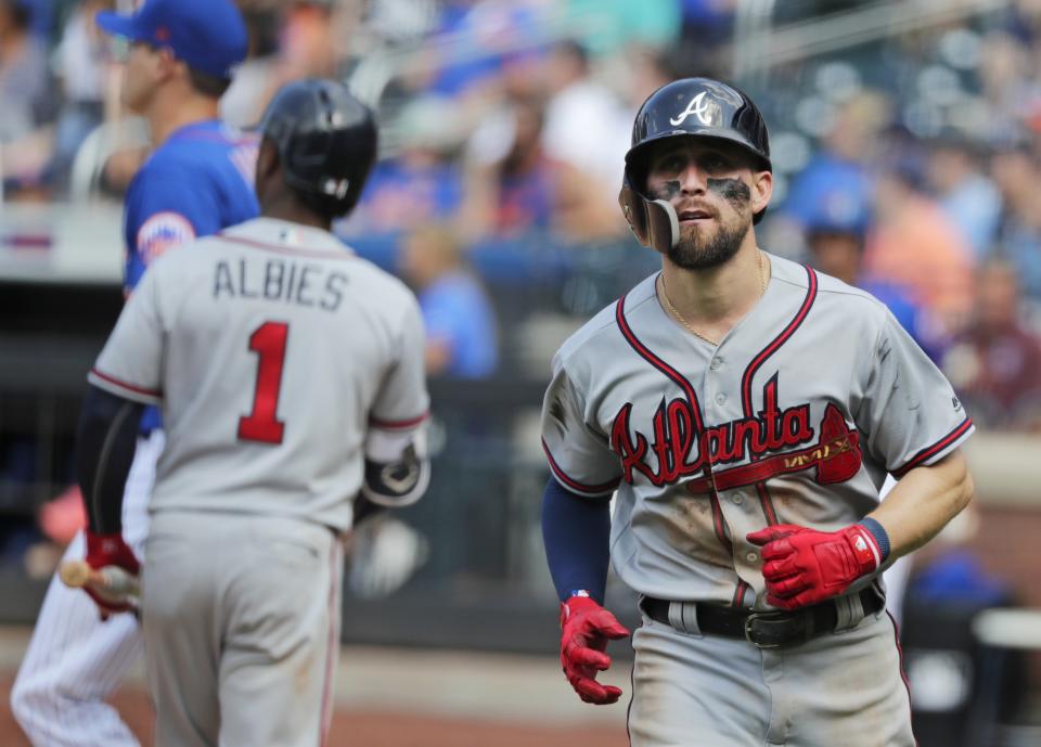 Atlanta Braves' Ender Inciarte, right, heads to his team's dugout after scoring on a single by Ronald Acuna Jr. during the ninth inning of a baseball game against the New York Mets, Sunday, Aug. 5, 2018, in New York. (AP Photo/Frank Franklin II)