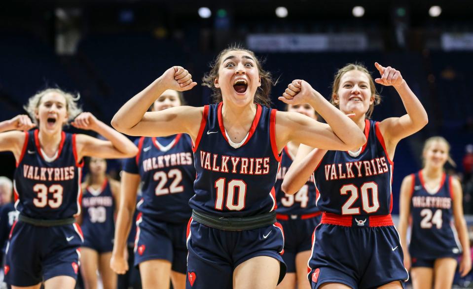Sacred Heart's Olivia Kaufman, Josie Gilvin and Olivia Lovan yell towards their fellow students in the stands after beating Cooper 50-29 at the second final four game Saturday of the 2022 Sweet Sixteen tournament in Lexington. March 12, 2022