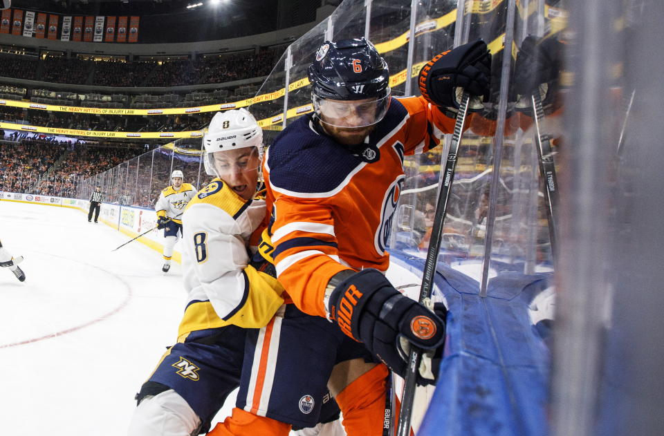 Nashville Predators' Kyle Turris (8) checks Edmonton Oilers' Adam Larsson (6) during third-period NHL hockey game action in Edmonton, Alberta, Saturday, Feb. 8, 2020. (Jason Franson/The Canadian Press via AP)