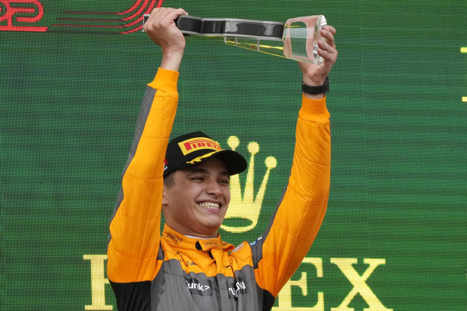 McLaren driver Lando Norris of Britain celebrates on the podium his third place at the Emilia Romagna Formula One Grand Prix, at the Enzo and Dino Ferrari racetrack, in Imola, Italy, Sunday, April 24, 2022. (AP Photo/Luca Bruno)