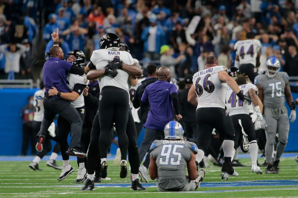 Baltimore Ravens players celebrate a Justin Tucker 66-yard field goal as Detroit Lions linebacker Romeo Okwara (95) sits on the field in the second half of an NFL football game against the Detroit Lions in Detroit, Sunday, Sept. 26, 2021. Baltimore won 19-17.