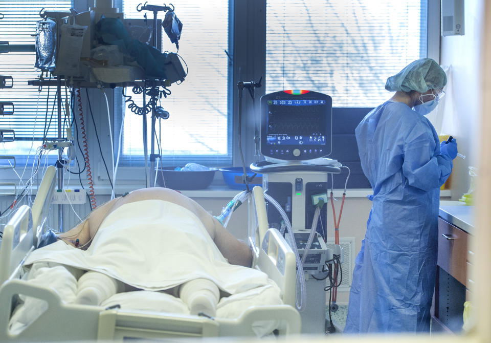 Medical staff attend to a patient at the COVID-19 ICU unit of the hospital in Bratislava, Slovakia, Tuesday, Nov. 23, 2021. Slovakia’s leaders have been proposing a national lockdown as hospitals across the European Union country are hitting their limits amid a record surge of coronavirus infections. Inspired by neighboring Austria, the government is set to discuss a lockdown plan for all, the vaccinated and unvaccinated, on its session on Wednesday. (Martin Baumann/TASR via AP)