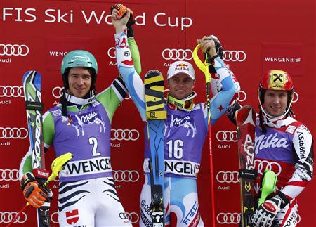 Felix Neureuther of Germany, Alexis Pinturault of France and and Marcel Hirscher of Austria (L-R) celebrate on the winners podium after the men's World Cup slalom ski race in Wengen January 19, 2014. REUTERS/Ruben Sprich