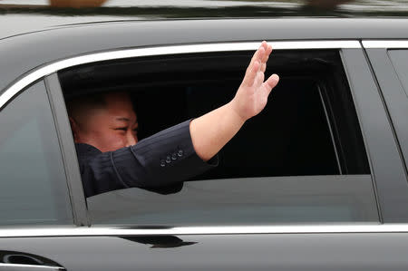 North Korea's leader Kim Jong Un waves from his vehicle after arriving at the Dong Dang railway station, Vietnam, at the border with China, February 26, 2019. REUTERS/Athit Perawongmetha