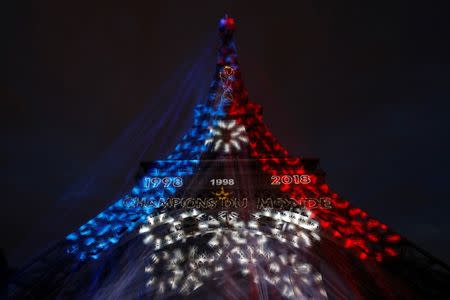 Soccer Football - World Cup - Final - France vs Croatia - Paris, France, July 15, 2018 - Blue, White, and Red lights and two World Cup stars are projected on the Eiffel Tower after France win the Soccer World Cup final. REUTERS/Philippe Wojazer