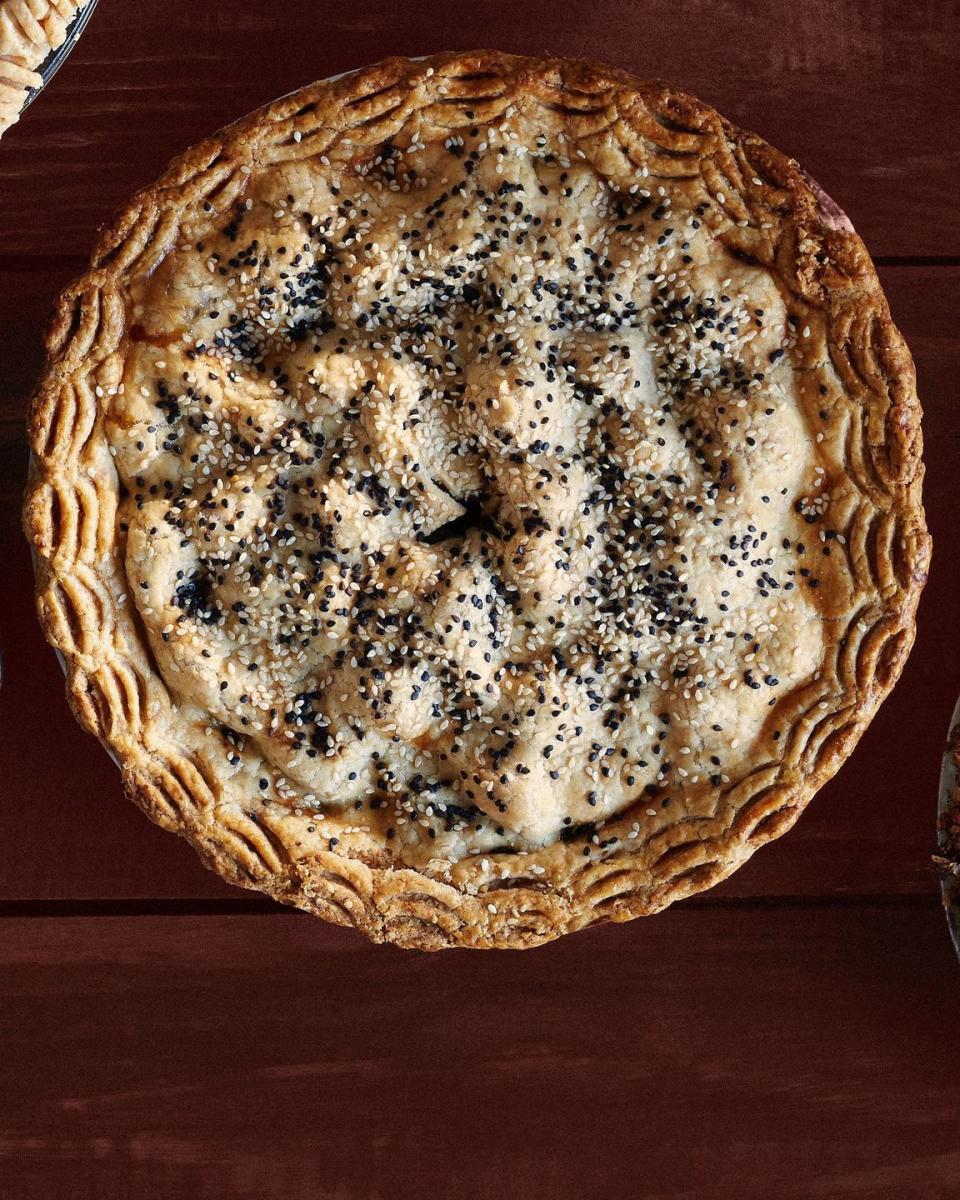 pear date and sesame pie with a double crust and sesame seeds on top
