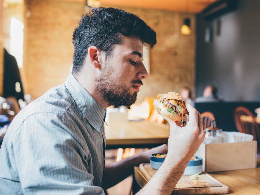 man eating burger