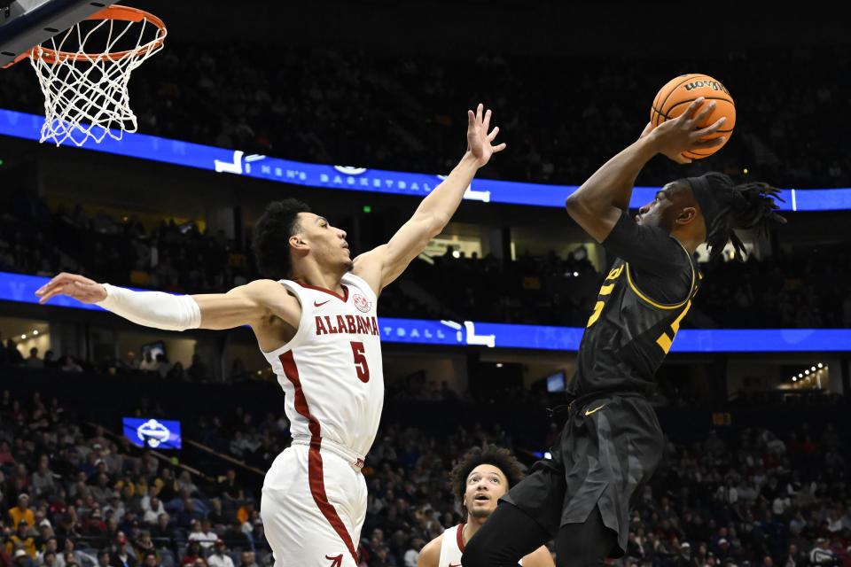 Missouri guard Sean East II shoots over Alabama guard Jahvon Quinerly (5) during the first half of an NCAA college basketball game in the semifinals of the Southeastern Conference Tournament, Saturday, March 11, 2023, in Nashville, Tenn. (AP Photo/John Amis)