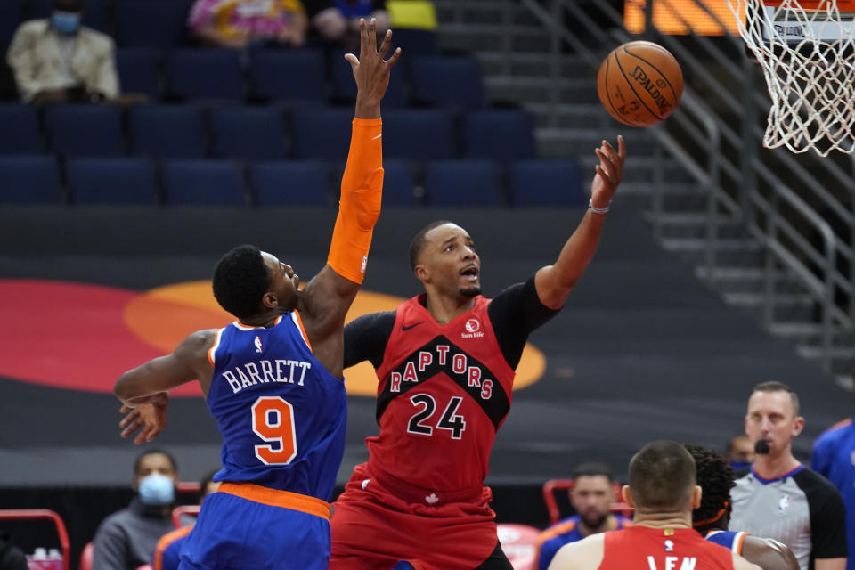 Toronto Raptors guard Norman Powell (24) shoots over New York Knicks guard RJ Barrett (9) during the second half of an NBA basketball game Thursday, Dec. 31, 2020, in Tampa, Fla. (AP Photo/Chris O'Meara)