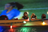 A college women's lacrosse match is shown on a big-screen TV above a chalkboard drink menu lit with multi-colored lights at The Sports Bra sports bar on Wednesday, April 24, 2024, in Portland, Ore. (AP Photo/Jenny Kane)