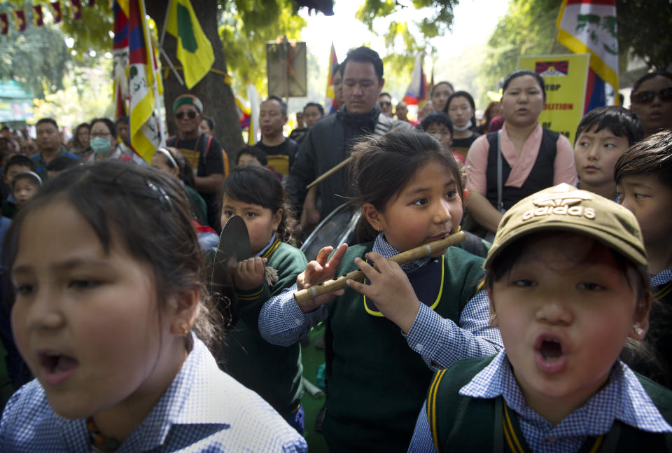 Tibetan school children sing their national anthem at the end of a march to mark the 60th anniversary of the March 10, 1959 Tibetan Uprising Day, in New Delhi, India, Sunday, March 10, 2019. The uprising of the Tibetan people against the Chinese rule was brutally quelled by Chinese army forcing the spiritual leader the Dalai Lama and thousands of Tibetans to come into exile. Every year exile Tibetans mark this day as the National Uprising Day. (AP Photo/Manish Swarup)
