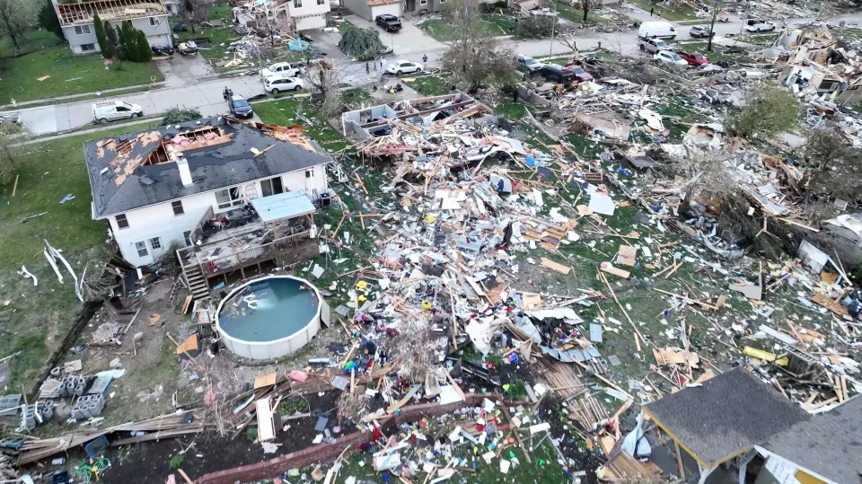A drone view shows people inspecting the site of damaged buildings in the aftermath of a tornado in Omaha on Friday. 