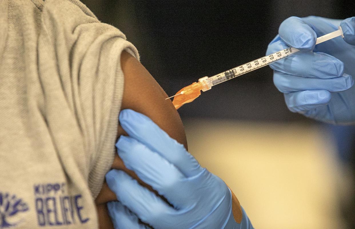 Medical personnel vaccinate students at a school in New Orleans on Jan. 25, 2022.