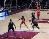 Houston's Quentin Grimes (24) takes a jump shot over Temple's Khalif Battle (0) in the second half of an NCAA college basketball game, Saturday, Jan. 23, 2021, in Philadelphia. Houston won 68-51. (AP Photo/Michael Perez)