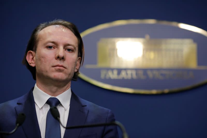 Prime Minister-designate Florin Citu attends a news conference, alongside former interim PM Ludovic Orban, after being nominated to form a transitional government