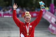 Cycling Cross-Country - Gold Coast 2018 Commonwealth Games - Mountain Bike - Women's Cross-Country - Nerang Mountain Bike Trails - Gold Coast, Australia - April 12, 2018. Annie Last of England poses with her gold medal. REUTERS/Paul Childs