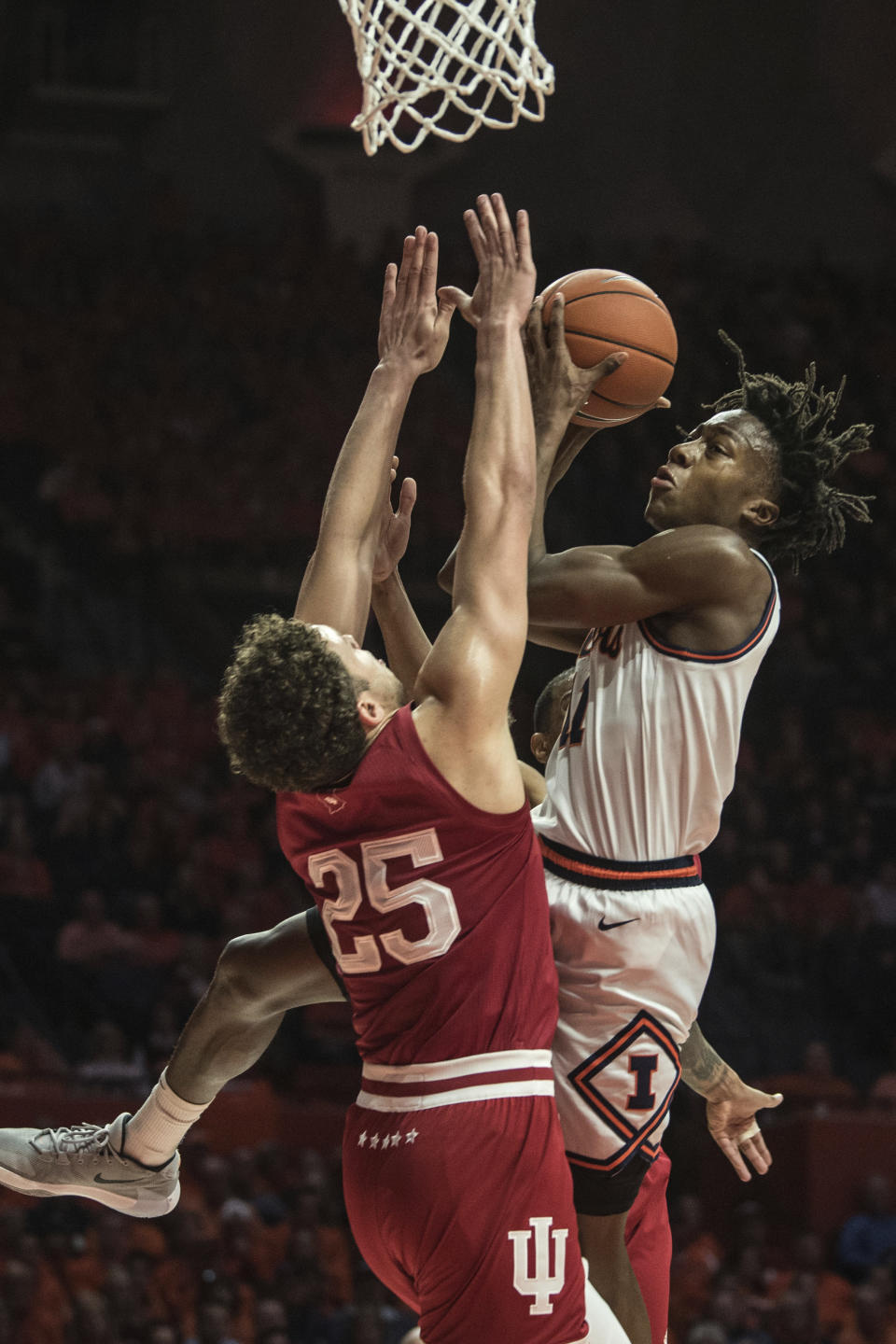Illinois' Ayo Dosunmu (11) goes up to shoot as Indiana's Race Thompson (25) defends in the first half of an NCAA college basketball game Sunday, March 1, 2020, in Champaign, Ill. (AP Photo/Holly Hart)