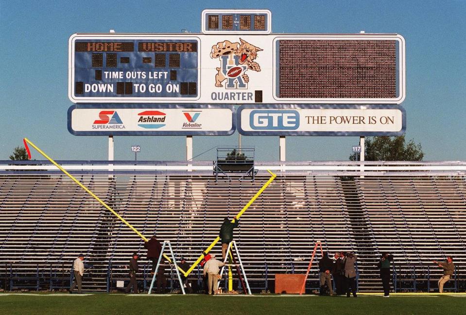 University of Kentucky employees install one of two new goal posts on Oct. 15, 1997, at the venue then known as Commonwealth Stadium. The goalposts replaced the ones the fans tore down 11 days earlier after the Wildcats defeated Alabama for the first time in 75 years with a 40-34 overtime victory.