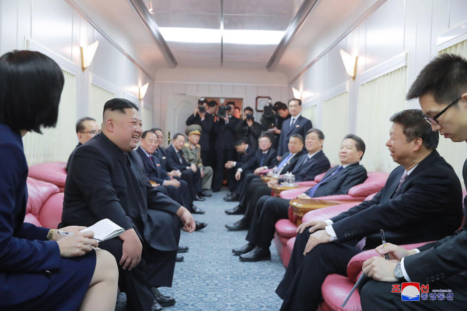 FILE- In this photo provided by the North Korean government, North Korean leader Kim Jong Un, second left, talks with Chinese Communist Party's International Department head Song Tao, second right, in a train on the way home from China, on Jan. 9, 2019. The content of this image is as provided and cannot be independently verified. Korean language watermark on image as provided by source reads: "KCNA" which is the abbreviation for Korean Central News Agency. (Korean Central News Agency/Korea News Service via AP, File)