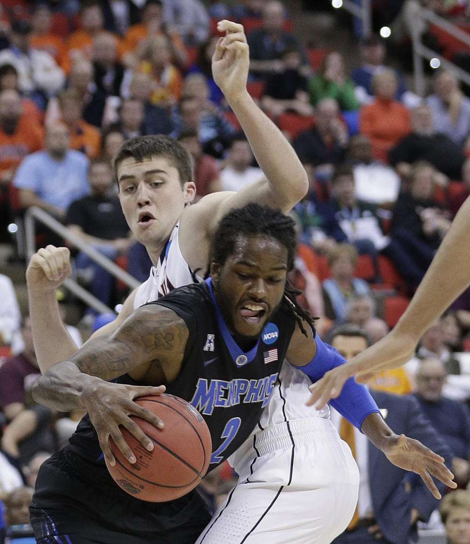 Memphis forward Shaq Goodwin (2) moves through Virginia guard Joe Harris (12) during the first half of an NCAA college basketball third-round tournament game, Sunday, March 23, 2014, in Raleigh. (AP Photo/Chuck Burton)