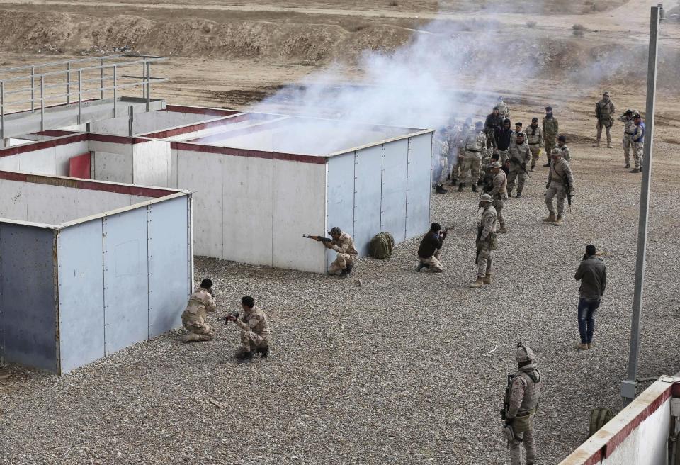 In this Wednesday, Feb. 1, 2017 photo, Nineveh police forces train with Spanish coalition members at Basmaya base 40 kilometers southeast of Baghdad, Iraq. The U.S.-led coalition is planning for the day Iraq will be free of the Islamic State group, ramping up the training of a future Mosul police force -- even as the battle for the city is temporarily on hold. The security forces are expected to move into villages of Ninevah province around Mosul and into parts of the city recently retaken from IS. The Iraqi military declared Mosul’s eastern half “fully liberated” in January and is now preparing to battle for the city’s western sector. (AP Photo/Karim Kadim)