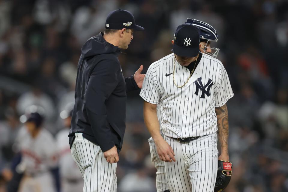 Oct 23, 2022; Bronx, New York, USA; New York Yankees relief pitcher Jonathan Loaisiga (43) hands the ball to manager Aaron Boone (17) after being taking out of the game seventh inning during game four of the ALCS for the 2022 MLB Playoffs at Yankee Stadium. Mandatory Credit: Brad Penner-USA TODAY Sports