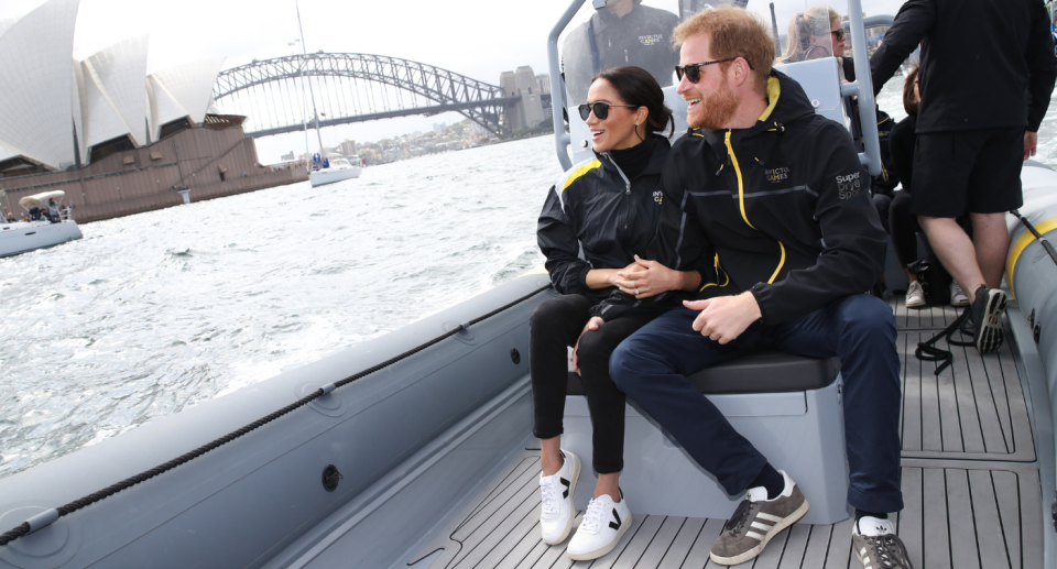 Meghan Markle wearing her $150 Veja V-10 sneakers during a trip to Australia (Photo via Getty)