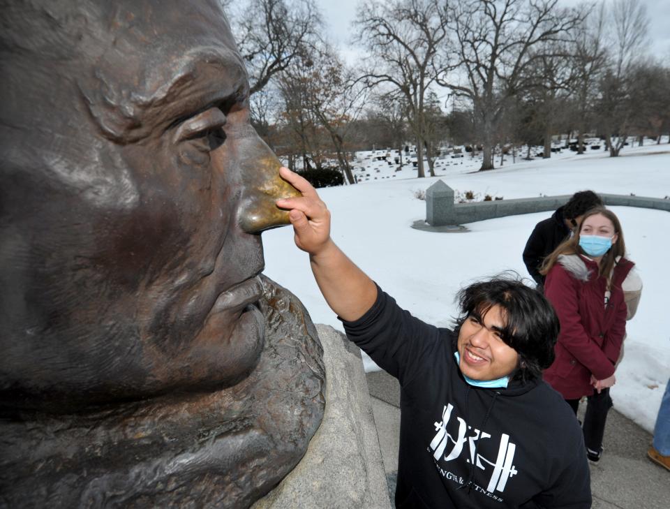 Alan Espinoza, 17, of Addison, Illinois, touches the nose on Abraham Lincoln's statue at the Lincoln Tomb for good luck while on a trip with his high school class on Wednesday Feb. 9, 2022.