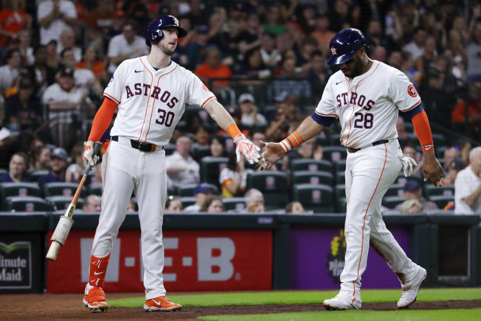 Houston Astros <a class="link " href="https://sports.yahoo.com/mlb/players/10480/" data-i13n="sec:content-canvas;subsec:anchor_text;elm:context_link" data-ylk="slk:Kyle Tucker;sec:content-canvas;subsec:anchor_text;elm:context_link;itc:0">Kyle Tucker</a> (30) and Jon Singleton (28) celebrate after a score by Singleton on a passed ball by Cleveland Guardians catcher <a class="link " href="https://sports.yahoo.com/mlb/players/11296/" data-i13n="sec:content-canvas;subsec:anchor_text;elm:context_link" data-ylk="slk:Bo Naylor;sec:content-canvas;subsec:anchor_text;elm:context_link;itc:0">Bo Naylor</a> during the third inning of a baseball game Thursday, May 2, 2024, in Houston. (AP Photo/Michael Wyke)