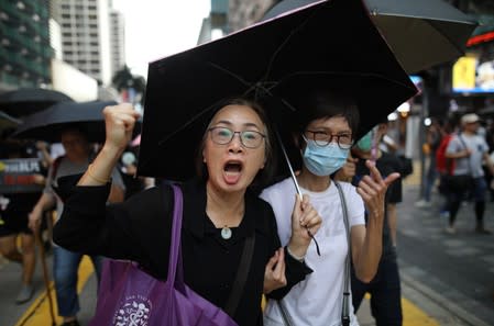 Anti-government demonstrators march in protest against the invocation of the emergency laws in Hong Kong