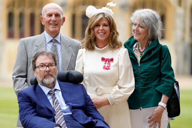 <p>Andrew Matthews / POOL / AFP via Getty</p> Kate Garraway with her husband Derek Draper and parents Gordon and Marilyn Garraway after being appointed a Member of the Order of the British Empire at Windsor Castle on June 28, 2023.