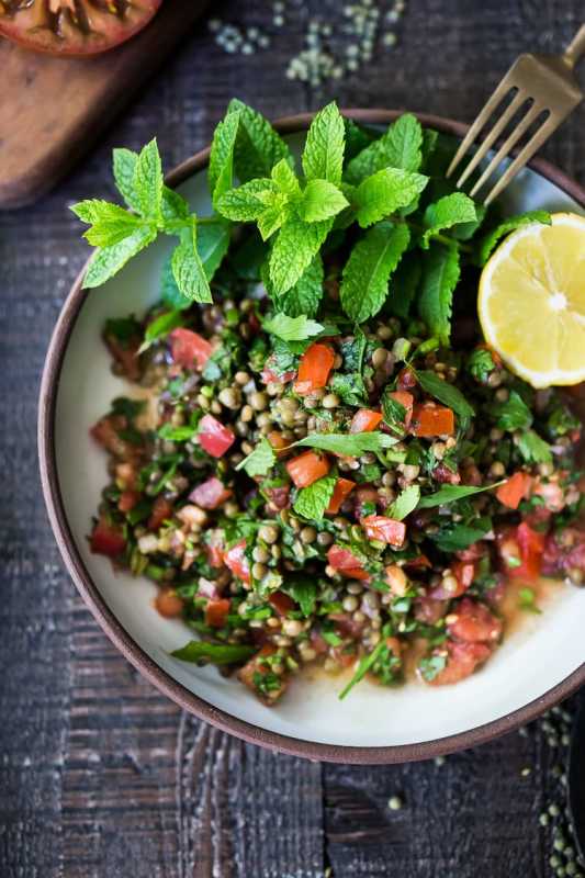 <p>Feasting at Home</p><p>This simple lentil tabouli salad is full of Middle Eastern flavor! Filling lentils are paired with summer tomatoes, lemon, mint, parsley and a unique combination of spices, and keeps for several days, perfect for midweek lunches or potlucks!</p><p><strong>Get the recipe: <a href="https://www.feastingathome.com/lentil-tabouli-salad/" rel="nofollow noopener" target="_blank" data-ylk="slk:Lentil Tabouli Salad;elm:context_link;itc:0;sec:content-canvas" class="link ">Lentil Tabouli Salad</a></strong></p>
