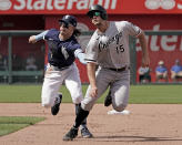 Chicago White Sox's Adam Engel (15) is tagged out by Kansas City Royals shortstop Bobby Witt Jr. as he is caught off base during the seventh inning of a baseball game Thursday, May 19, 2022, in Kansas City, Mo. (AP Photo/Charlie Riedel)