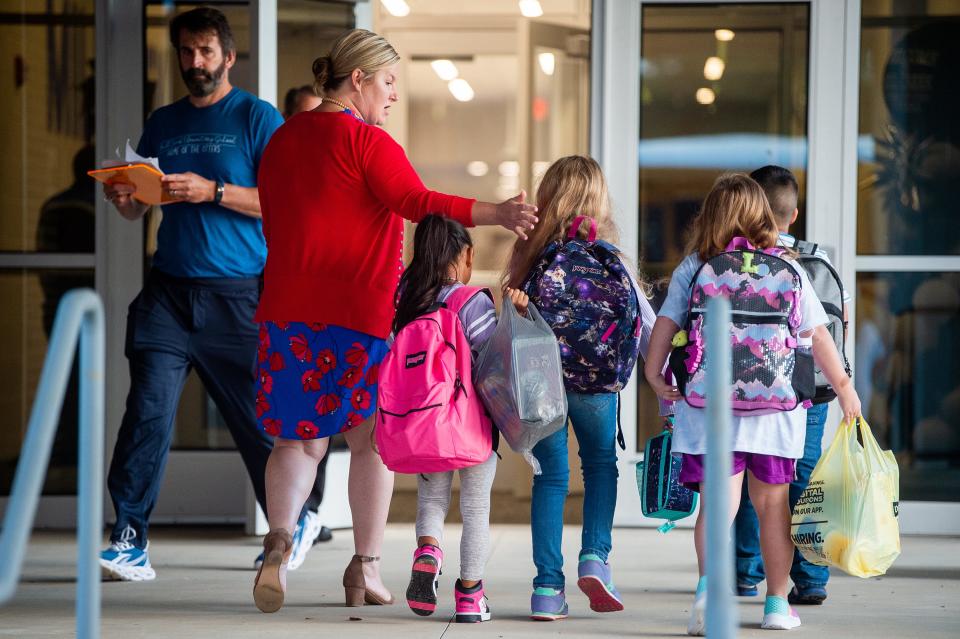 Mill Creek Elementary students arrive for the first day of school on Aug. 8, 2023, in Knoxville.