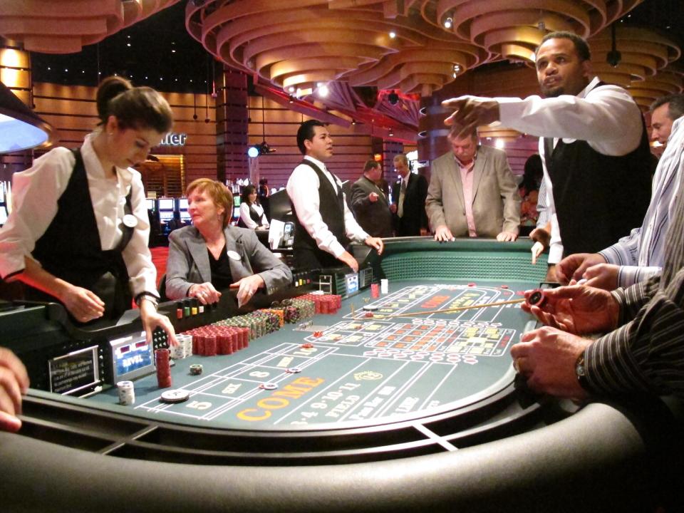 In this March 28, 2012, photo, craps dealers handle bets for customers at Revel, the Atlantic City N.J., casino that had its first invitation-only test night on March 28. The $2.4 billion resort opens its doors to the public on Monday, April 2. (AP Photo/Wayne Parry)
