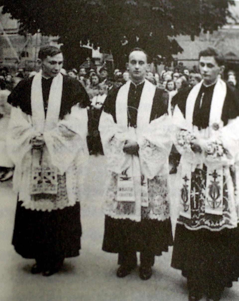 George, left, with Joseph, right, newly ordained in 1951  - Reuters